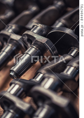 A heavy industrial worker in a factory works with metal on angle grinders while hot sparks are produced as a result. A heavy industrial worker in a factory works with metal on angle grinders while hot sparks are produced as a result. 84494791