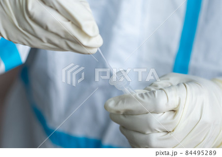 The doctor with PPE suit, Doctor is using a test coronavirus(covid-19) with the use of an ATK test kit by nasal swab. The doctor with PPE suit, Doctor is using a test coronavirus(covid-19) with the use of an ATK test kit by nasal swab. 84495289