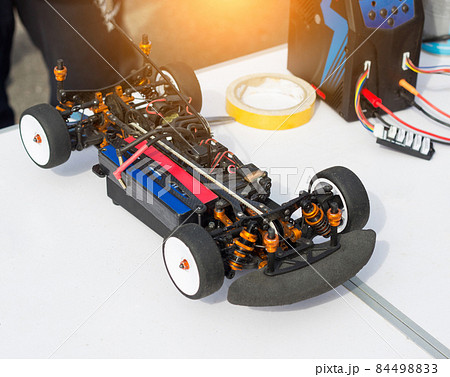 Preparation of an electric radio-controlled car before the start of a car sport competition, close-up, auto 84498833