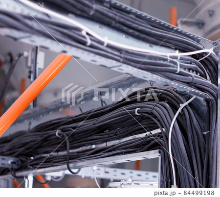 Wiring harnesses for black electrical wiring, close-up, electrical cables, industry 84499198