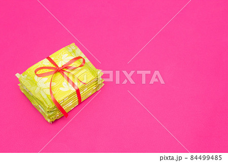 A pile of feminine sanitary pads on a pink background, close-up, copy space, periodicity, gynecology A pile of feminine sanitary pads on a pink background, close-up, copy space, periodicity, gynecology 84499485