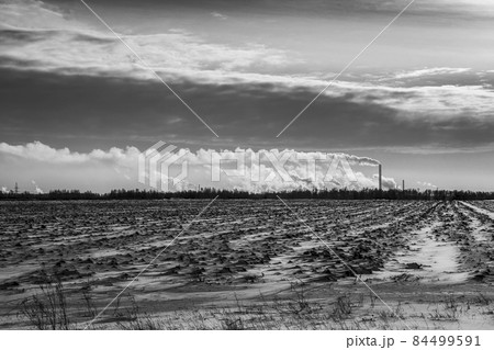 Winter view of the oil refinery from the suburban agricultural fields. Winter view of the oil refinery from the suburban agricultural fields. 84499591