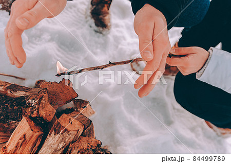 man and wonan kindle a bonfire, campfire. Winter hike theme man and wonan kindle a bonfire, campfire. Winter hike theme 84499789