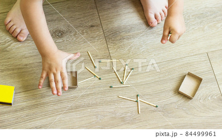The child plays with matches, matches matches into boxes, fire, danger, ignition 84499961