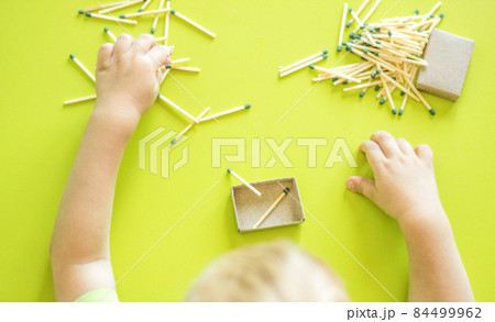 A small child plays with matches, matches matches into boxes, close-ups, fire, lucifer match, hand A small child plays with matches, matches matches into boxes, close-ups, fire, lucifer match, hand 84499962