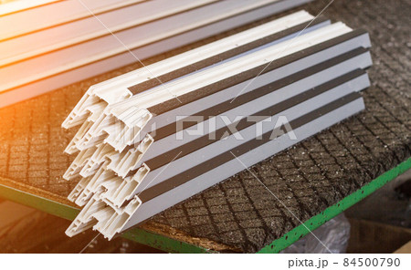 Production of pvc windows, plastic pvc profile lies on the table, close-up, section Production of pvc windows, plastic pvc profile lies on the table, close-up, section 84500790