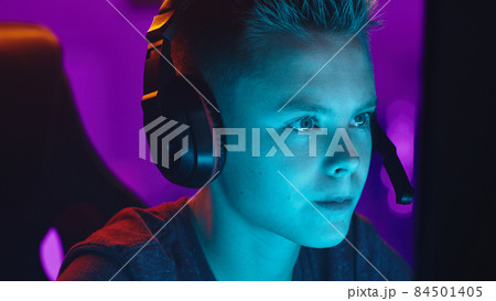 Teenager discussing videogame with teammates Teenager discussing videogame with teammates 84501405