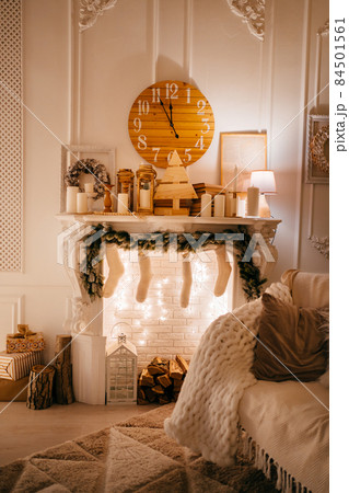 New Year's atmosphere. an armchair by the fireplace decorated for the New Year.  84501561