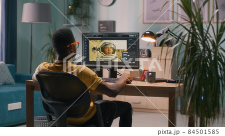Black guy using photo editor on computer Black guy using photo editor on computer 84501585