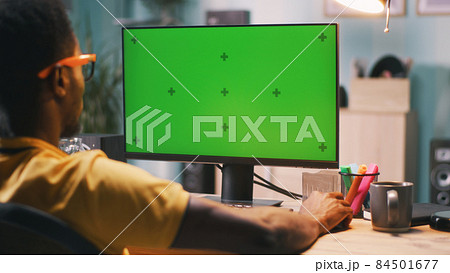 Black man using computer with chromakey screen Black man using computer with chromakey screen 84501677