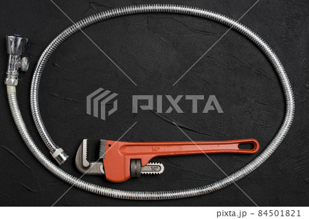wrench flexible connector dark table. High quality photo wrench flexible connector dark table. High quality photo 84501821