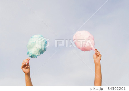 hands holding cotton candy. High quality photo hands holding cotton candy. High quality photo 84502201