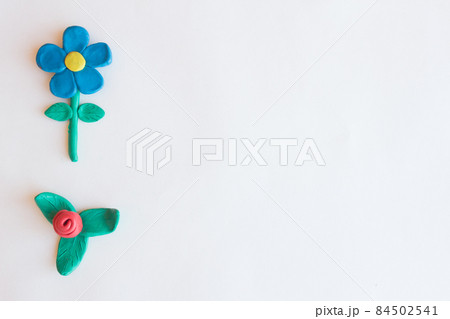 Flowers made of clay on a white background Flowers made of clay on a white background 84502541