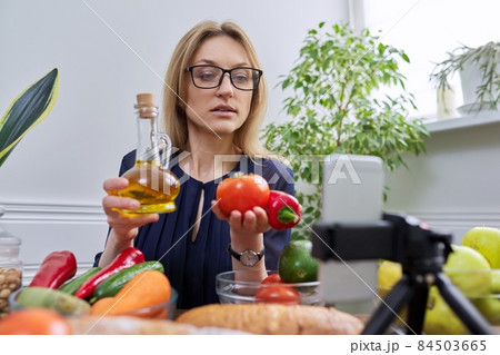 Woman nutritionist recording a video about healthy food, nutrition Woman nutritionist recording a video about healthy food, nutrition 84503665