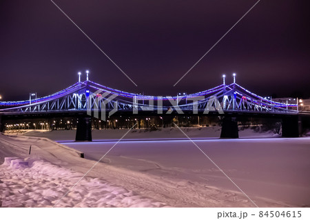 Night landscape - a beautiful bridge over the river decorated with festive lights Night landscape - a beautiful bridge over the river decorated with festive lights 84504615
