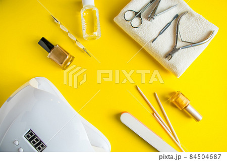 Set of tools for manicure and nail care on a yellow background. Place for text. Set of tools for manicure and nail care on a yellow background. Place for text. 84504687