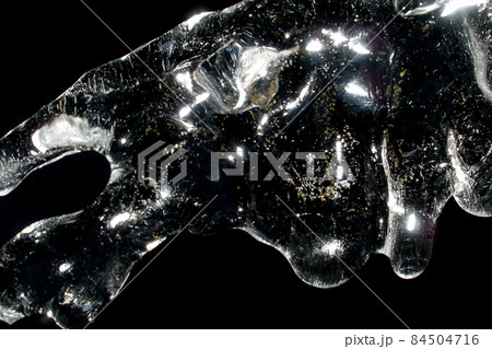 Unusual sparkling icicles on a black background 84504716