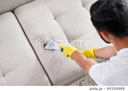 Close-up of housekeeper holding modern washing vacuum cleaner and