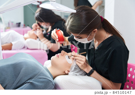 Process of eyelash extensions in the beauty studio 84510147
