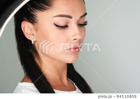 Portrait of a beautiful woman with long eyelashes 84510809