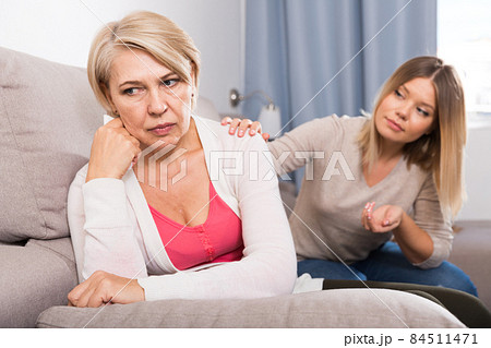 daughter comforts a sad mother 84511471