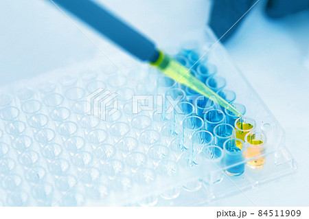 Lab Worker Adding Liquid to Test Tubes Lab Worker Adding Liquid to Test Tubes 84511909
