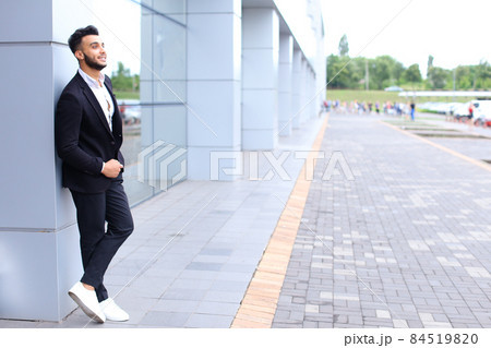 Arabic guy in business center stands smiling walking slow 84519820