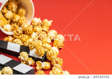 Sweet caramel popcorn and clapper board Sweet caramel popcorn and clapper board 84520550