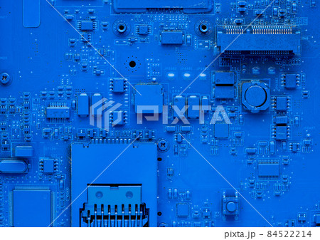 Computer motherboard. Classic blue background with pc backdrop, close up. Single color microchip Computer motherboard. Classic blue background with pc backdrop, close up. Single color microchip 84522214