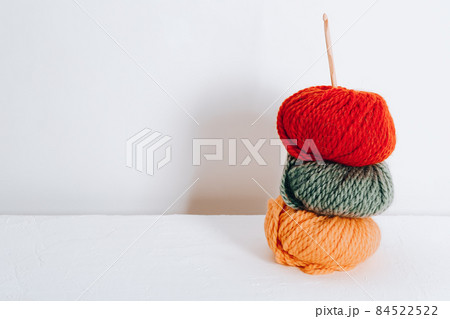 Balls of wool for knitting in autumn colors on a white background Balls of wool for knitting in autumn colors on a white background 84522522
