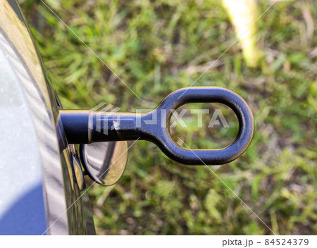 Screwed on the towing hook in a passenger car for towing a car, close-up. Transportation Screwed on the towing hook in a passenger car for towing a car, close-up. Transportation 84524379