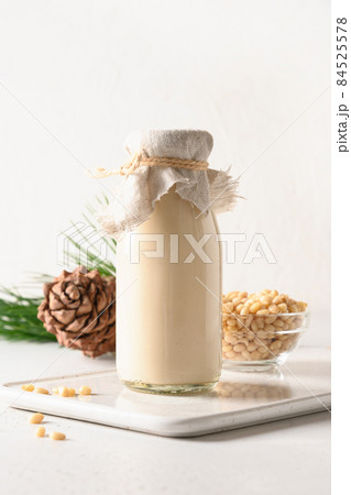Cedar nut milk and nuts on white background. Alternative plant based milk. 84525578