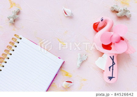Open notepad and seashells decoration on pink woman desk workspace. Lifestyle, planning sea vacation, summer holidays concept. To Do List template, empty page, mockup. Flat lay, top view, copy space Open notepad and seashells decoration on pink woman desk workspace. Lifestyle, planning sea vacation, summer holidays concept. To Do List template, empty page, mockup. Flat lay, top view, copy space 84526642
