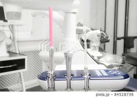 Close-up dentist saliva ejector. Dental work in clinic. Operation, tooth replacement. Medicine, health, stomatology concept. Office where dentist conducts inspection and concludes. Close-up dentist saliva ejector. Dental work in clinic. Operation, tooth replacement. Medicine, health, stomatology concept. Office where dentist conducts inspection and concludes. 84528736