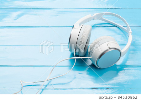 Headphones on wooden table 84530862