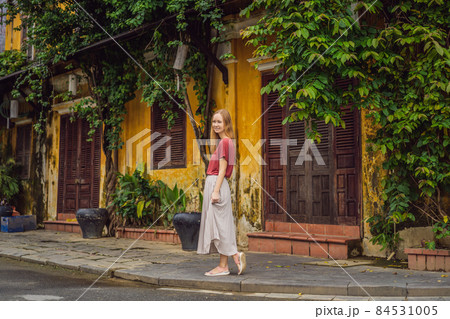Woman tourist on background of Hoi An ancient town, Vietnam. Vietnam opens to tourists again after quarantine Coronovirus COVID 19 84531005