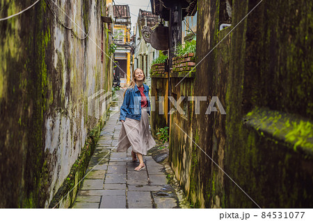 Woman tourist on background of Hoi An ancient town, Vietnam. Vietnam opens to tourists again after quarantine Coronovirus COVID 19 84531077