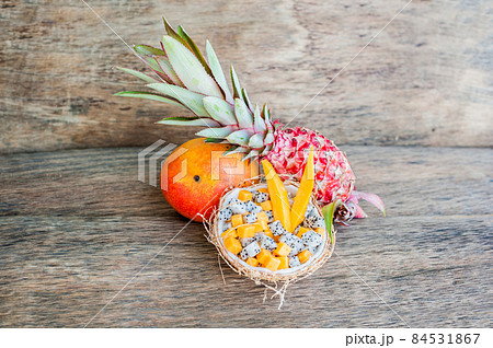 Fruit salad with dragon fruit and papaya in half a coconut 84531867