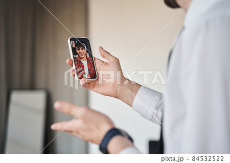 Unrecognizable businessman having video call with his friend or colleague 84532522