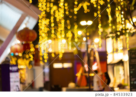 blurred image Decorative outdoor string lights hanging on tree in the garden at night time festivals season - decorative Christmas lights - happy new year blurred image Decorative outdoor string lights hanging on tree in the garden at night time festivals season - decorative Christmas lights - happy new year 84533923