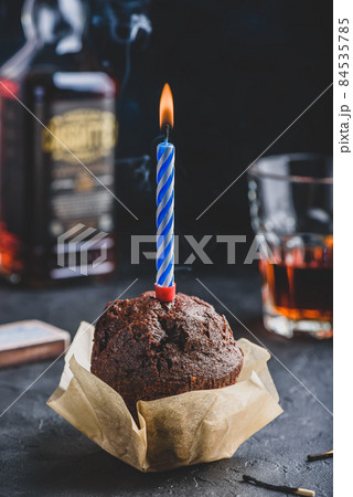 Chocolate muffin with birthday candle 84535785