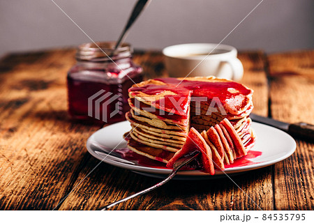 Stack of american pancakes with red berry jam 84535795