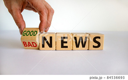 Good or bad news. Hand flips a cube and changes the words 'bad news' to 'good news'. Beautiful white background. Business concept. Copy space. 84536693