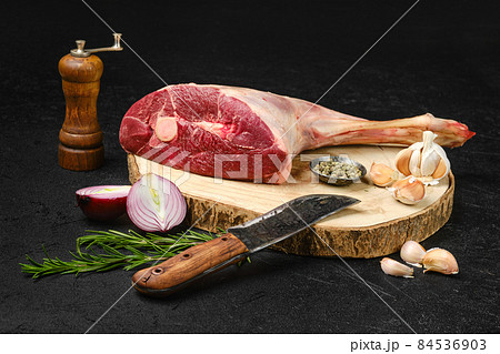 Raw lamb short cut leg, sirloin off on wooden stump Raw lamb short cut leg, sirloin off on wooden stump 84536903
