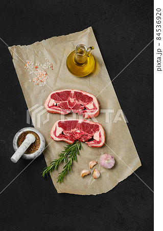 Top view of raw lamb double loin chop on wrapping paper Top view of raw lamb double loin chop on wrapping paper 84536920