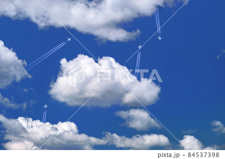 Many distant passenger jet planes flying on high altitude on clear blue sky leaving white smoke trace of contrail behind. Busy air transportation concept 84537398