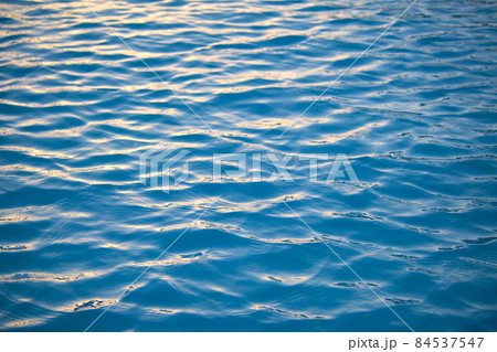 Closeup seascape surface of blue sea water with small ripple waves. Closeup seascape surface of blue sea water with small ripple waves. 84537547