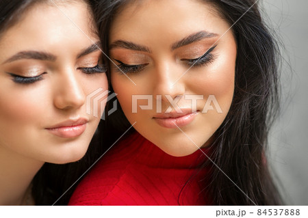 Portrait of young beautiful two women with long lashes and closed eyes after eyelash extensions. Portrait of young beautiful two women with long lashes and closed eyes after eyelash extensions. 84537888