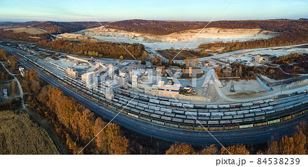 Aerial view of cargo train loaded with crushed sandstone materials at mine factory. Railway transportation of open pit mining ore 84538239