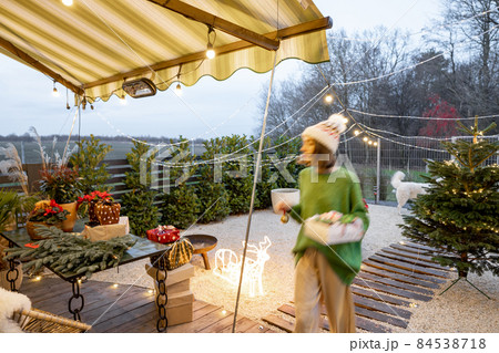 New Year's decorated backyard with a woman walking New Year's decorated backyard with a woman walking 84538718